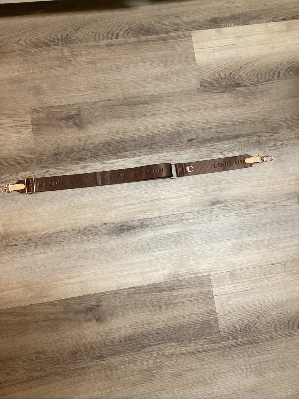 Rich brown colored guitar crossbody strap.